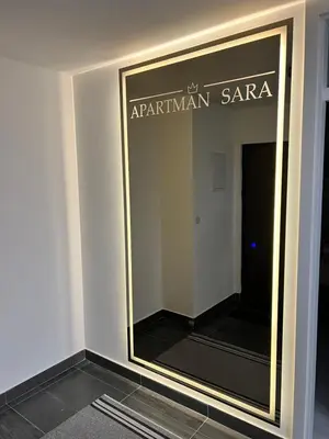a mirror on a wall in a dressing room at Apartman Sara in Teslić