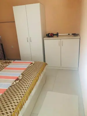 a bedroom with a bed and white cabinets in it at Apartment Medi in Visoko
