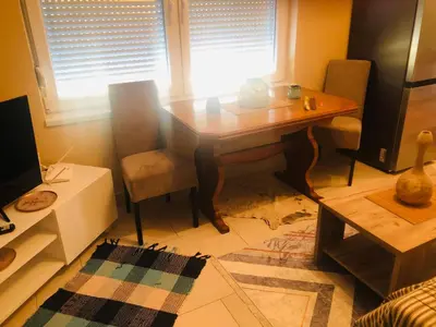a living room with a wooden table and a chair at Apartment Medi in Visoko