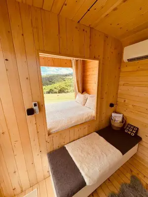 a small room with a window in a wooden cabin at Petrovf Place