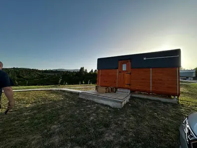 a small wooden building on the side of a field at Petrovf Place