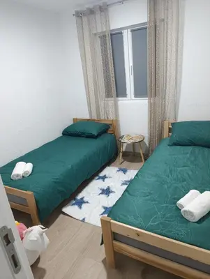 a bedroom with two beds and a window at Apartman ARDA in Jajce