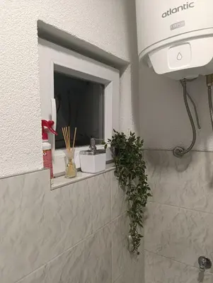 a bathroom with a sink and a window at Apartman ARDA in Jajce