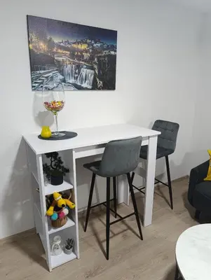 a white desk with a chair and a wine glass at Apartman ARDA in Jajce