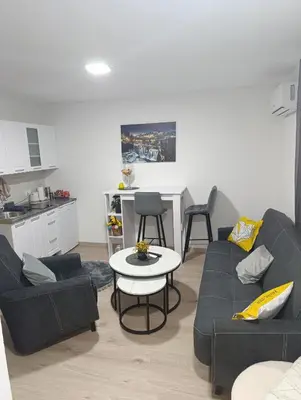 a living room with a couch and a table at Apartman ARDA in Jajce