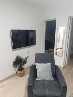 a black chair with a pillow in a living room at Apartman ARDA in Jajce