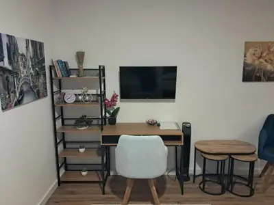 a desk with a computer and a chair in a room at Galija in Tomislavgrad