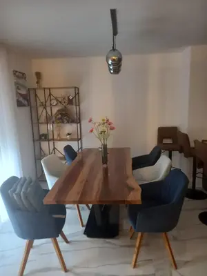 a dining room with a wooden table and chairs at Galija in Tomislavgrad