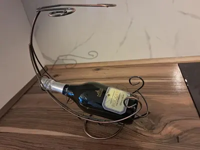 a bottle of wine is hooked up to a wall at Galija in Tomislavgrad