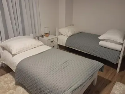 a bedroom with two beds and a nightstand withskirts at Galija in Tomislavgrad