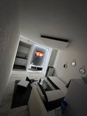 a living room with a couch and a table at Luxury Apartman Dzafic in Sanski most