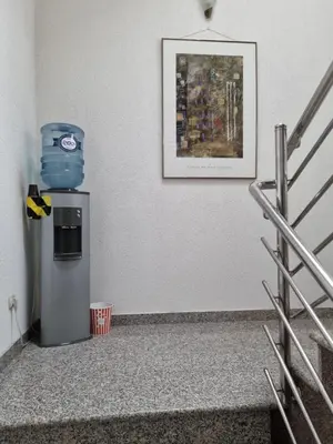 a refrigerator in a room with a picture on the wall at City Bridge Guest House in Bihać
