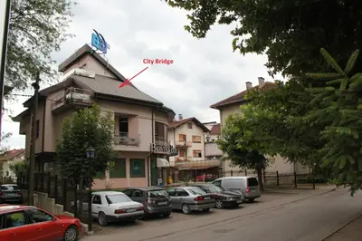 a building with a clock on the top of it at City Bridge Guest House in Bihać