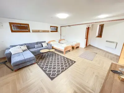 a living room with a couch and a table at Nessy Bihać in Bijelo Brdo