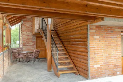 a staircase leading up to a brick building with a table at Nessy Bihać in Bijelo Brdo