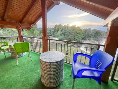 a balcony with chairs and a table and a view at Nessy Bihać in Bijelo Brdo
