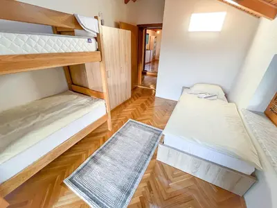 a room with two bunk beds and a hallway at Nessy Bihać in Bijelo Brdo