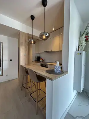 a kitchen with a counter with chairs and a refrigerator at Villa Laura in Gornji Vakuf