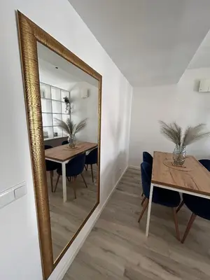 a dining room with a mirror and a table at Villa Laura in Gornji Vakuf