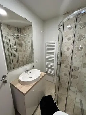 a white bathroom with a sink and a shower at Villa Laura in Gornji Vakuf