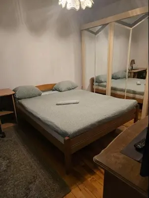 a bedroom with a bed with a mirror on it at Pyramid Apartment in Visoko