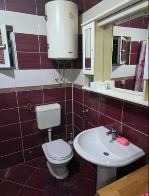 a bathroom with a toilet and a sink at Pyramid Apartment in Visoko