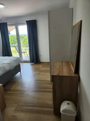 a bedroom with a bed and a table with a mirror at Villa Zeleno Brdo in Visoko