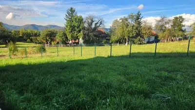 a fence in the middle of a grass field at Villa Zeleno Brdo in Visoko
