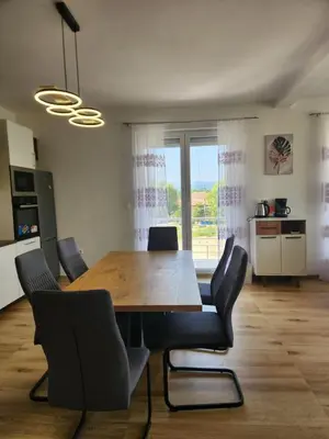 a dining room with a wooden table and chairs at Villa Zeleno Brdo in Visoko