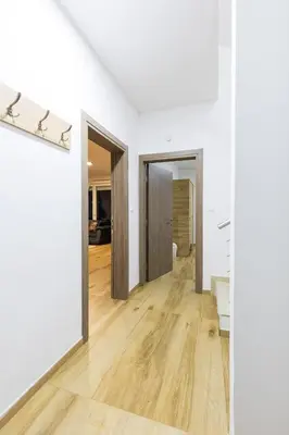 an empty room with white walls and wooden floors at Villa Zeleno Brdo in Visoko