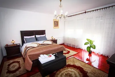 a bedroom with a bed and a table in it at Apartment Red House in Visoko