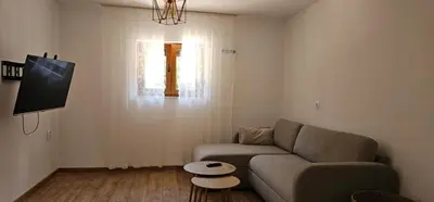 a living room with a couch and a table at Studio Šumska prica in Livno