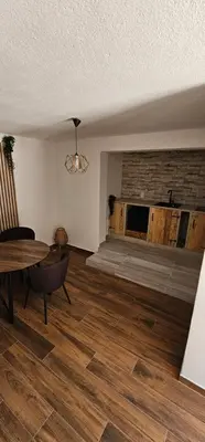 an empty living room with a table and a couch at Studio Šumska prica in Livno