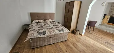 a bedroom with a bed and a wooden floor at Studio Šumska prica in Livno