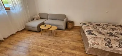a living room with a couch and a table at Studio Šumska prica in Livno