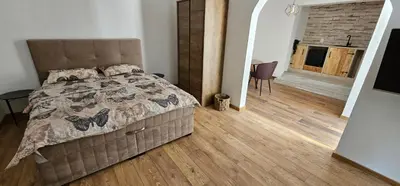 a bedroom with a bed and a wooden floor at Studio Šumska prica in Livno