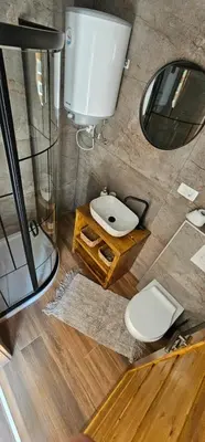 a bathroom with a toilet and a mirror at Studio Šumska prica in Livno