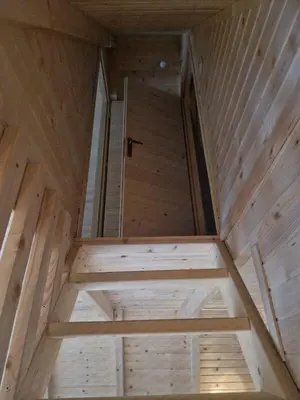 an inside view of a wooden cabin with a window at Fikro's Resort in Kulen Vakuf