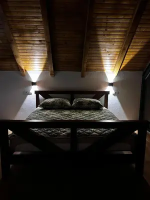 a bed in a room with two pillows on it at Vikendica Radoš