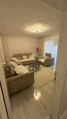 a living room with two couches and a table at Moj dom Petrićevac in Banja Luka