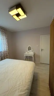 a bedroom with a large bed and a phone at Moj dom Petrićevac in Banja Luka