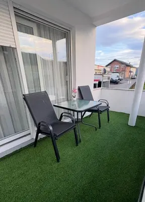 a patio with two chairs and a table on a balcony at Moj dom Petrićevac in Banja Luka