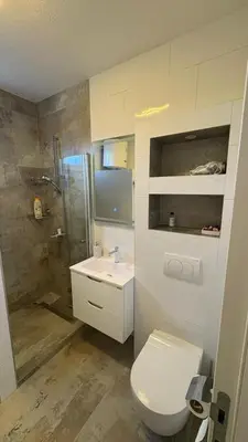 a bathroom with a toilet and a sink and a shower at Moj dom Petrićevac in Banja Luka