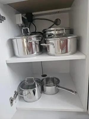 a shelf with pots and pans in a kitchen at Moj dom Petrićevac in Banja Luka