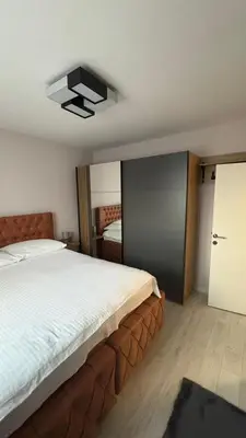 a bedroom with a large bed and a ceiling fan at Moj dom Petrićevac in Banja Luka
