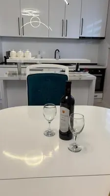 a bottle of wine and two wine glasses on a table at Moj dom Petrićevac in Banja Luka