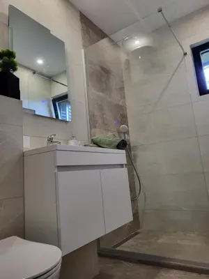 a bathroom with a white sink and a shower at Friends 2 Vlašić in Vlasic