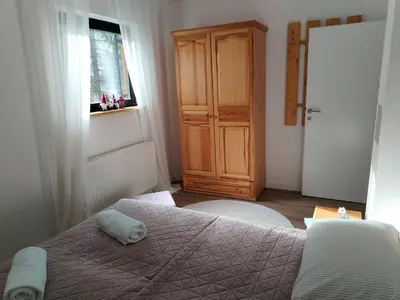 a bedroom with a bed and a wooden cabinet at Friends 2 Vlašić in Vlasic