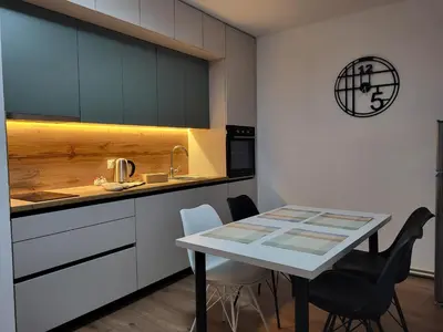 a kitchen with a table and chairs in a room at Friends 2 Vlašić in Vlasic