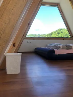 a bed in a room with a large window at Vikednica ZEA